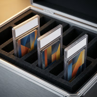 Close-up of the foam divider rows separating graded card slabs in the storage case