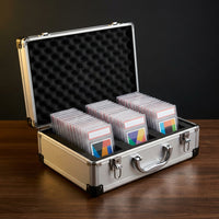 Aluminium graded card storage case open on a desk with three foam rows of slabs