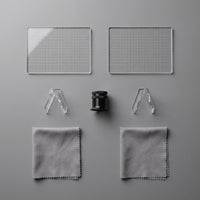 Centering tool kit flat lay, two grid overlays, loupe, two stands and two cloths